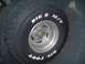 1988 Ford Bronco - A spare tire with 'BIG O M/T' and 'BIG FOOT' lettering is mounted on a silver wheel.
