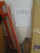 2003 Mazda Protege - A handwritten note is taped to a wall in a garage, with various items stored around it.