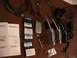 1985 Ford Crown Victoria LTD - Collection of Motorola cell phones, batteries, chargers, and user guides.