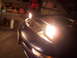 1995 Ford Probe - The pop-up headlights of a blue 1995 Ford Probe are illuminated in this front-view shot.