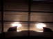 1995 Ford Probe - Headlights illuminated on a car hood with two distinct fins, parked in front of a garage.