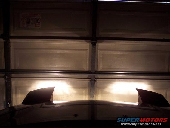 car headlights on in a garage