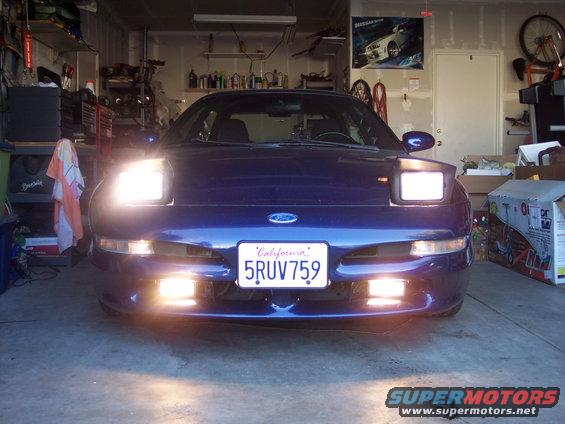 Blue Ford Probe with pop-up headlights and California license plate 5RUV759 parked in a garage