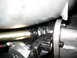 1985 Ford Crown Victoria LTD - Greasy automotive part, possibly from a linkage system, with visible mounting hardware.