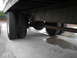 1999 Ford F-800 - Close-up view of the rear dual wheels and the undercarriage of a large truck.