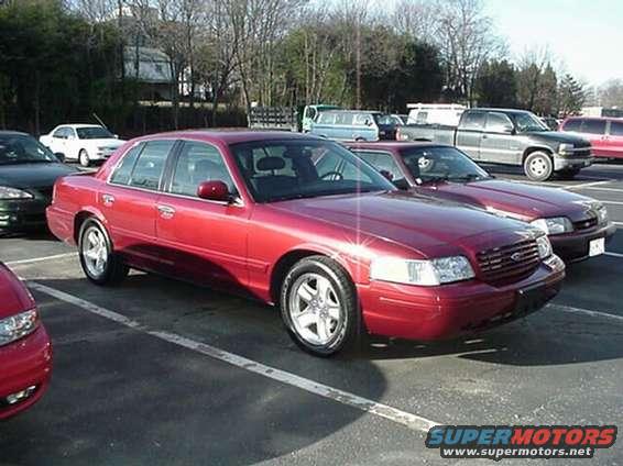 Red 2002 Ford Crown Victoria parked in a lot, front quarter view