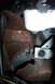 1968 Ford Mustang - Close-up view of heavily rusted metal and mechanical components within a vehicle.
