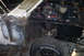 1968 Ford Mustang - 1968 Ford Mustang engine bay undergoing restoration work, with visible rust on the inner fender.