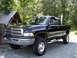 2002 Dodge 2500 - Black 2002 Dodge 2500 pickup truck parked outdoors with a tall exhaust pipe.