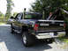 2002 Dodge 2500 - This black Dodge 2500 pickup truck features chrome exhaust stacks and a 4x4 decal on the tailgate.