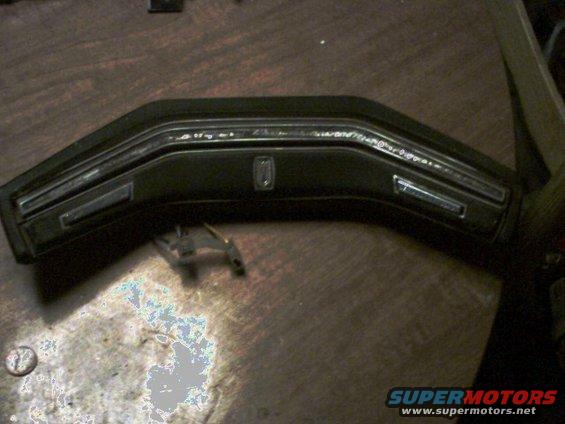 Black dashboard trim with chrome accents and a central emblem