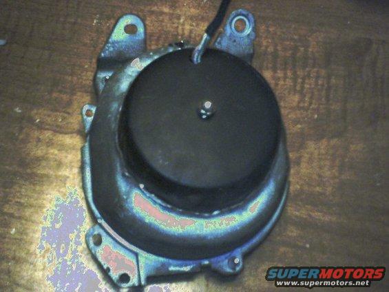 Black automotive part with mounting bracket and wire