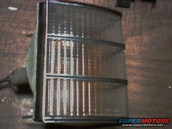 Clear tail light assembly with vertical fluting