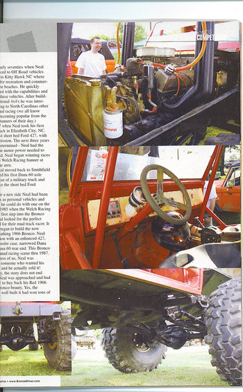 Custom off-road vehicle interior with roll cage and large steering wheel; engine bay visible