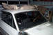 1968 Ford Mustang - White 1968 Ford Mustang coupe in garage, windshield removed for repair, roof covered.