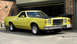 1978 Ford Ranchero - This yellow coupe utility vehicle has a distinctive grille and a black hood, parked in front of a brick garage.