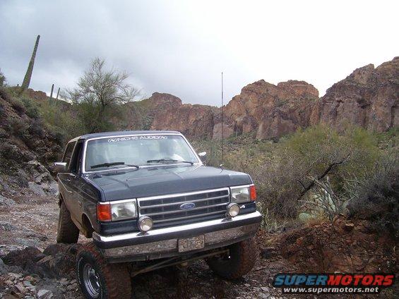 1991 Ford Bronco on rocky desert trail, front 3/4 view