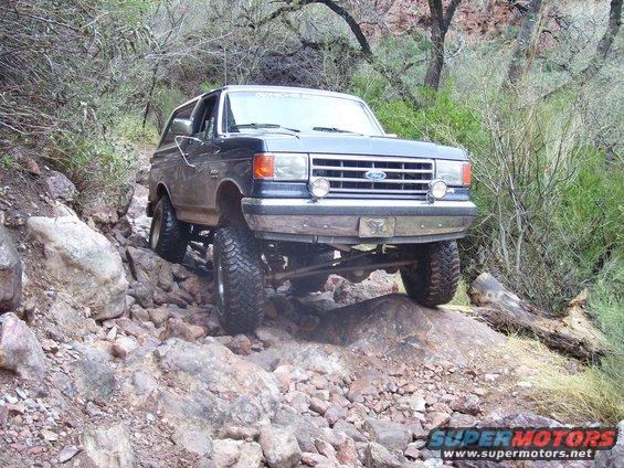 Ford Bronco navigating a rocky trail, tires high off the ground