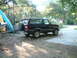 1992 Ford Bronco - This black 1992 Ford Bronco is parked on a driveway with kayaks and a boat trailer nearby.