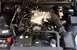 2003 Mercury Marauder - The engine bay of a vehicle is shown, various components like the intake, alternator, and battery.