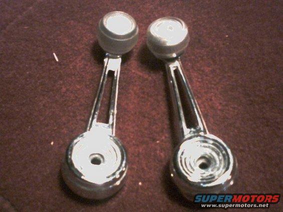 Two chrome window crank handles with black knobs