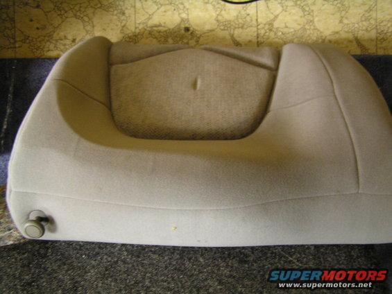 Tan car seat cushion with a small knob on the side