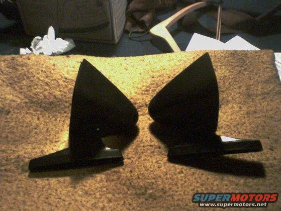 two black car mirrors on a carpeted surface