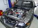 1990 Ford Mustang - Custom V8 engine installed in a car's engine bay, chrome components and aftermarket parts.