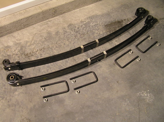 p1200001.jpg [b]Ford SuperDuty V-Code Leaf Spring Installation on a 2000 Ford Excursion[/b]

[b]The Problem[/b]
It's widely known that Excursions, while sharing a similar chassis to the F-250, do not share the same leaf springs from the factory. Due to the SUV body style of the Excursion, leaf springs specific to the Excursion come from the factory so the Excursion will fit in your standard garage and parking garage. The result: front leaf springs with significantly reduced travel (on 4x4 models) that eventually sag and leave less than 1" of leaf spring travel...further resulting in a very harsh ride.

[b]Why V-Code Springs instead of standard Excursion springs?[/b]
After 175,000 miles, I had about 5/8" of clearance between the leaf spring and the bump-stop. I could feel every bump I'd drive over on the road. It was time to swap springs. Instead of swapping back to factory Excursion springs, I opted for "V-Code springs" which ended up providing me with 1.5" of additional frontend lift over my sagging factory springs.

[b]Parts Needed[/b]
(8 ) Nuts - Part # N805480-S426
(2) V-Code Leaf Springs - Part # 2C3Z-5310-HA
(2) U-Bolts - unfortunately the u-bolts I ordered at the dealer were incorrect. My Excursion has a rounded-square u-bolt style, but I was given square-style u-bolts (Square-style u-bolt Part # is F81Z-5705-BA)

[b]Tools Needed[/b]
We'll cover tools needed in each step.

[b]Estimated Time Required[/b]
6-8 hours

[b]Difficulty[/b]
7 out of 10 (1 being easiest, 10 being hardest)

[b]Questions/Comments?[/b]
Discuss them in [url=http://www.supermotors.net/clubs/fordexcursions/forums/thid-6099]this forum thread[/url].