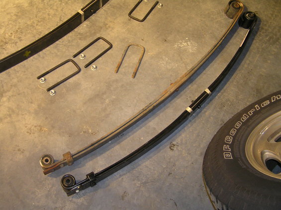 p1200074.jpg New leaf spring (bottom) and old leaf spring (top). There doesn't appear to be a significant difference when compared side-by-side (other than the fresh coat of paint). However, the old leaf springs have 175,000+ miles on them and are fatigued. The new leaf springs will be stiffer and actually do have more arch to them to provide the additional lift.