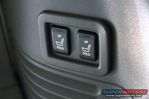 close-up of two power seat buttons labeled 'UP' and 'FOLD' on a textured surface