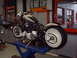 1995 Harley-Davidson Fat Boy - Motorcycle undergoing service, showing its engine and wide rear tire on a hydraulic lift.