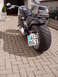 1995 Harley-Davidson Fat Boy - Motorcycle parked on a brick driveway, showing its rear tire and license plate.