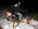 2005 Honda TRX 450 R - A rider poses on a Honda ATV in a snowy, outdoor setting at night, with a "SUPERMOTORS" watermark visible.