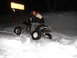 2005 Honda TRX 450 R - A man rides an ATV through deep snow, with a trail sign visible in the background.