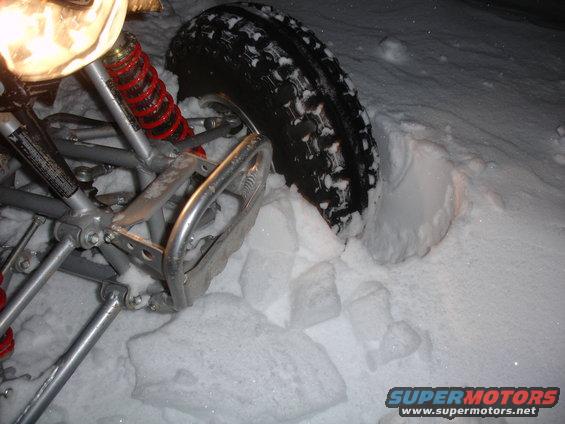 2005 Honda TRX 450 R front suspension and tire in snow