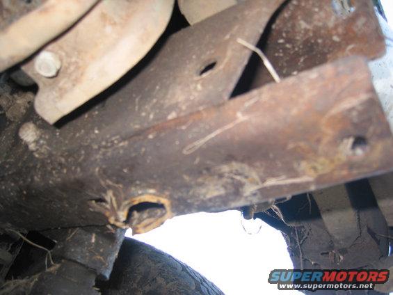 close-up of rusty metal parts and suspension components under a vehicle