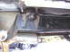 1978 Ford Bronco - Close-up of the undercarriage, showing the frame and exhaust system of a vehicle.