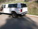 1986 Ford F-350 - White pickup truck with a camper shell is seen from a 3q-front angle.