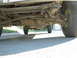 1986 Ford F-350 - The photo shows the undercarriage of a truck, focusing on the rear axle and suspension system.