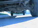 1986 Ford F-350 - The underside of a 1986 Ford F-350 reveals its robust suspension and drivetrain components.