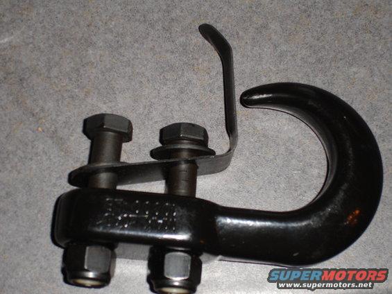 Black tow hook assembly with two bolts and nuts. Text is visible on the hook