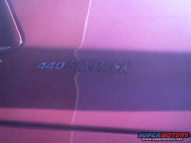 close-up of "440 SIX PACK" emblem on a purple car