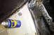 1968 Ford Mustang - A can of WD-40 rests on a dirty interior panel, revealing signs of rust and wear.