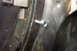 1968 Ford Mustang - A close-up view shows a bolt secured in a metal panel, likely part of a vehicle's body or frame.