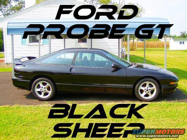 Black 1993 Ford Probe GT parked in front of a house with a carport