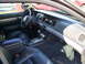 2003 Mercury Marauder - The interior of a car is shown, black leather seats and a gray dashboard with a car stereo.