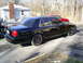 2003 Mercury Marauder - Side view of a black 2003 Mercury Marauder parked in a driveway.