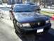2003 Mercury Marauder - A black 2003 Mercury Marauder is parked in a driveway, with a pickup truck visible behind it.