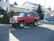1979 Ford Bronco - This lifted red Ford Bronco features chrome wheels and a prominent grille.